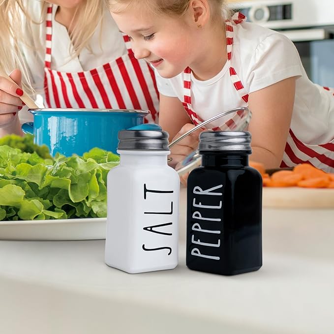Farmhouse Salt and Pepper Shakers Set, a cute black and white premium glass shakers with stainless steel lids in a black metal holder, perfect for adding a vintage kitchen decor charm, great as a gift